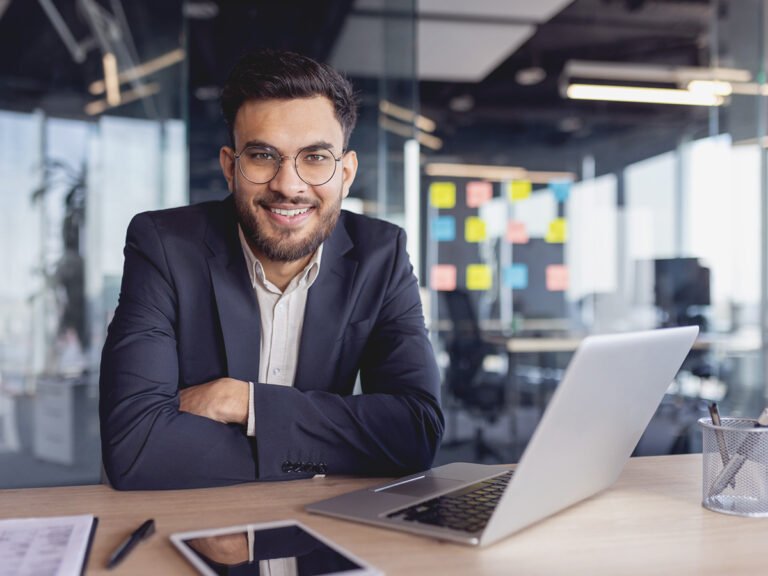Male immigration lawyer handling visa processes via laptop on his desk