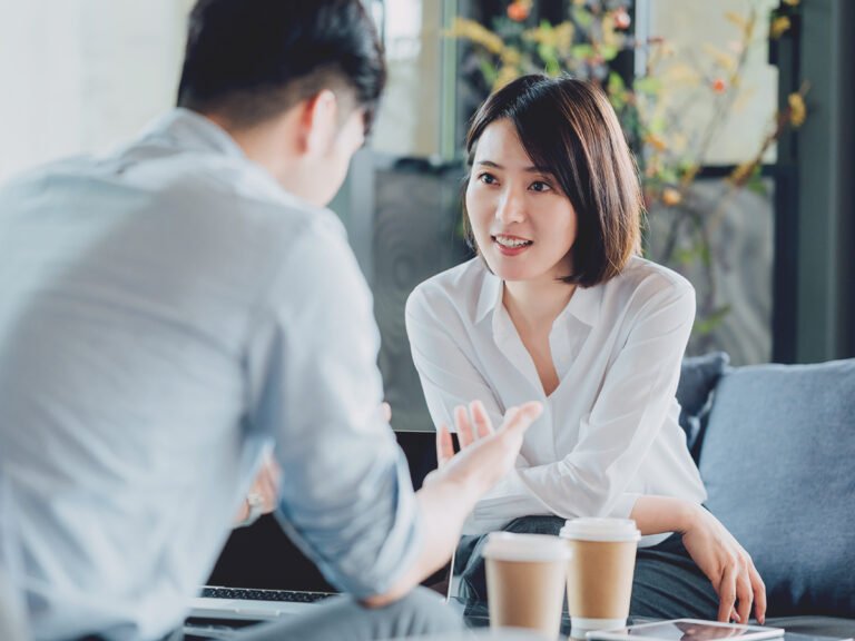They discuss business immigration tips in an office setting