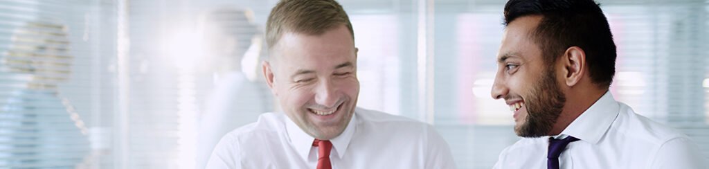 Two men talk about e-2 visa source of funds during a consultation meeting