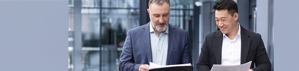 They hold documents while talking about renewing e2 visa for immigrant business owners